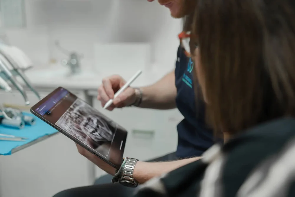 Dentista mostra radiografia su tablet